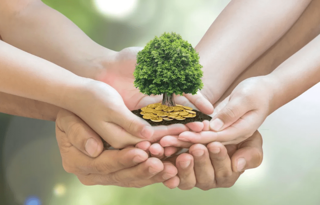 A group of people holding hands with coins and a tree.