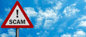 A red and white sign sitting in front of some clouds