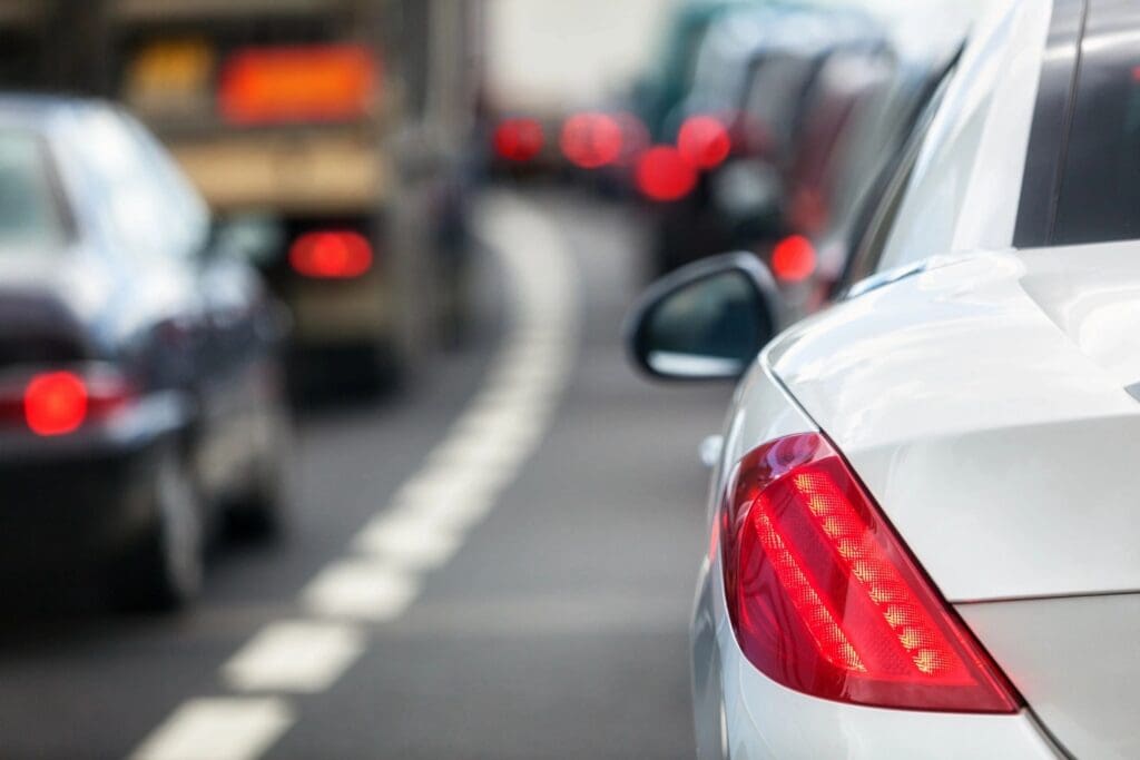 A close up of the side lights on cars in traffic.