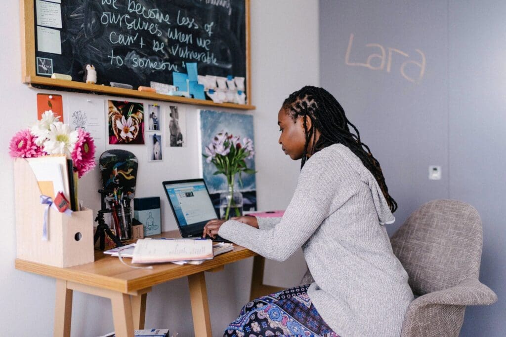 A woman sitting at her desk using a laptop.