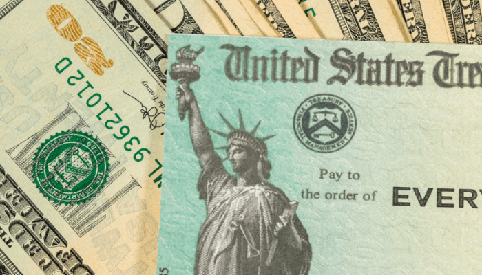 A close up of the statue of liberty on top of money.