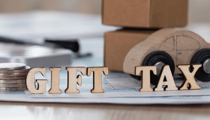 A wooden letter sitting on top of paper.