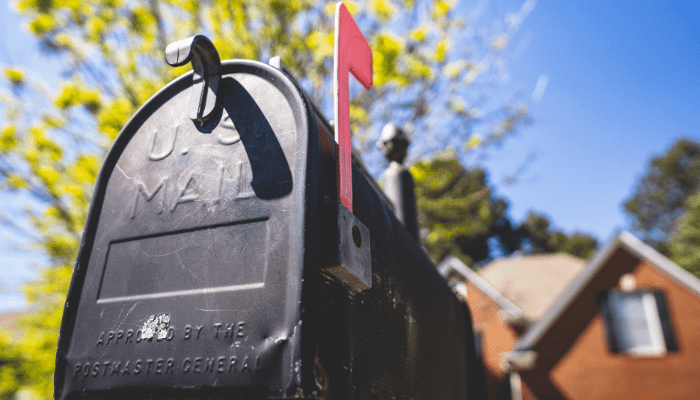 A close up of the mail slot on a mailbox.