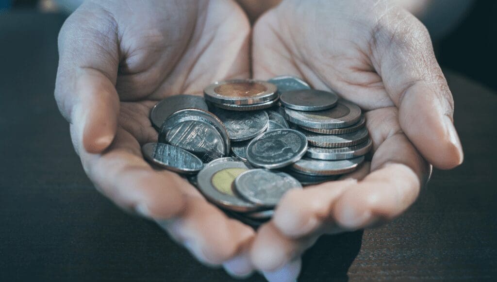 A person holding coins in their hands