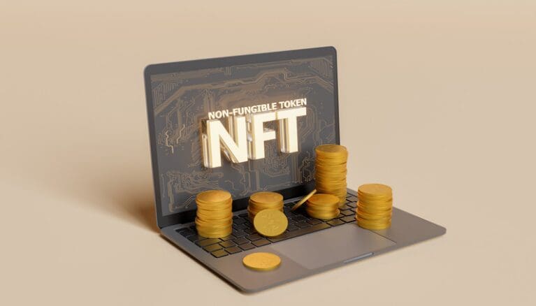 A laptop with coins on the screen and a nft logo.