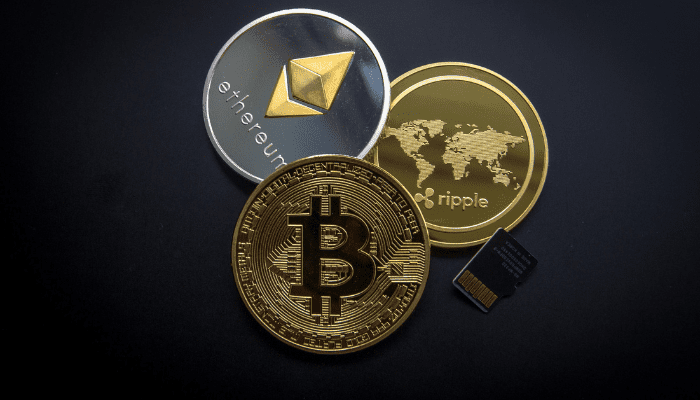 Bitcoin, Ethereum, Ripple coins and memory card.